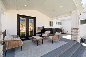 Wooden terrace with french doors, an outdoor living space, and a grill
