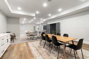 Dining space with light wood-style flooring and recessed lighting