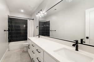 Full bath featuring double vanity and shower / tub combo with curtain