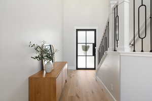 Entryway with wood-type flooring and a high ceiling