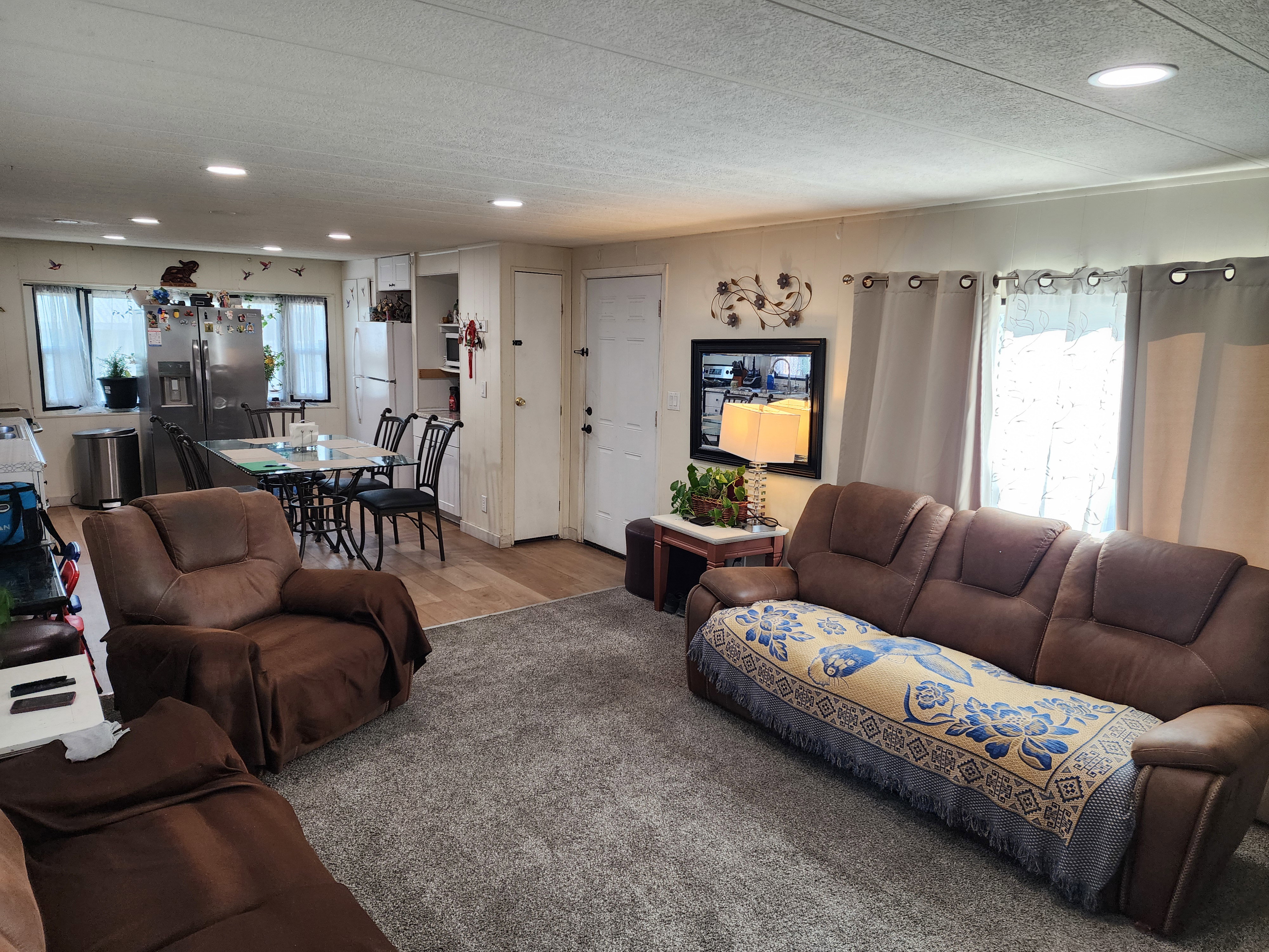 Living room featuring healthy amount of natural light, recessed lighting, a textured ceiling, and wood finished floors