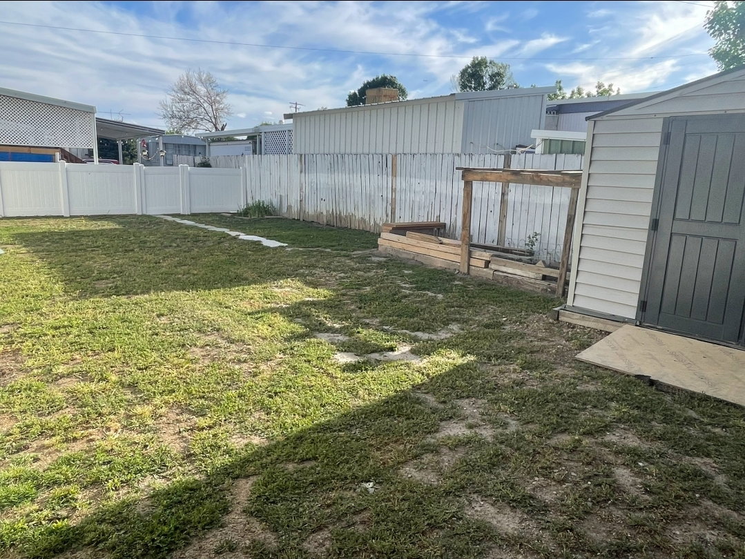 Fenced backyard with a shed