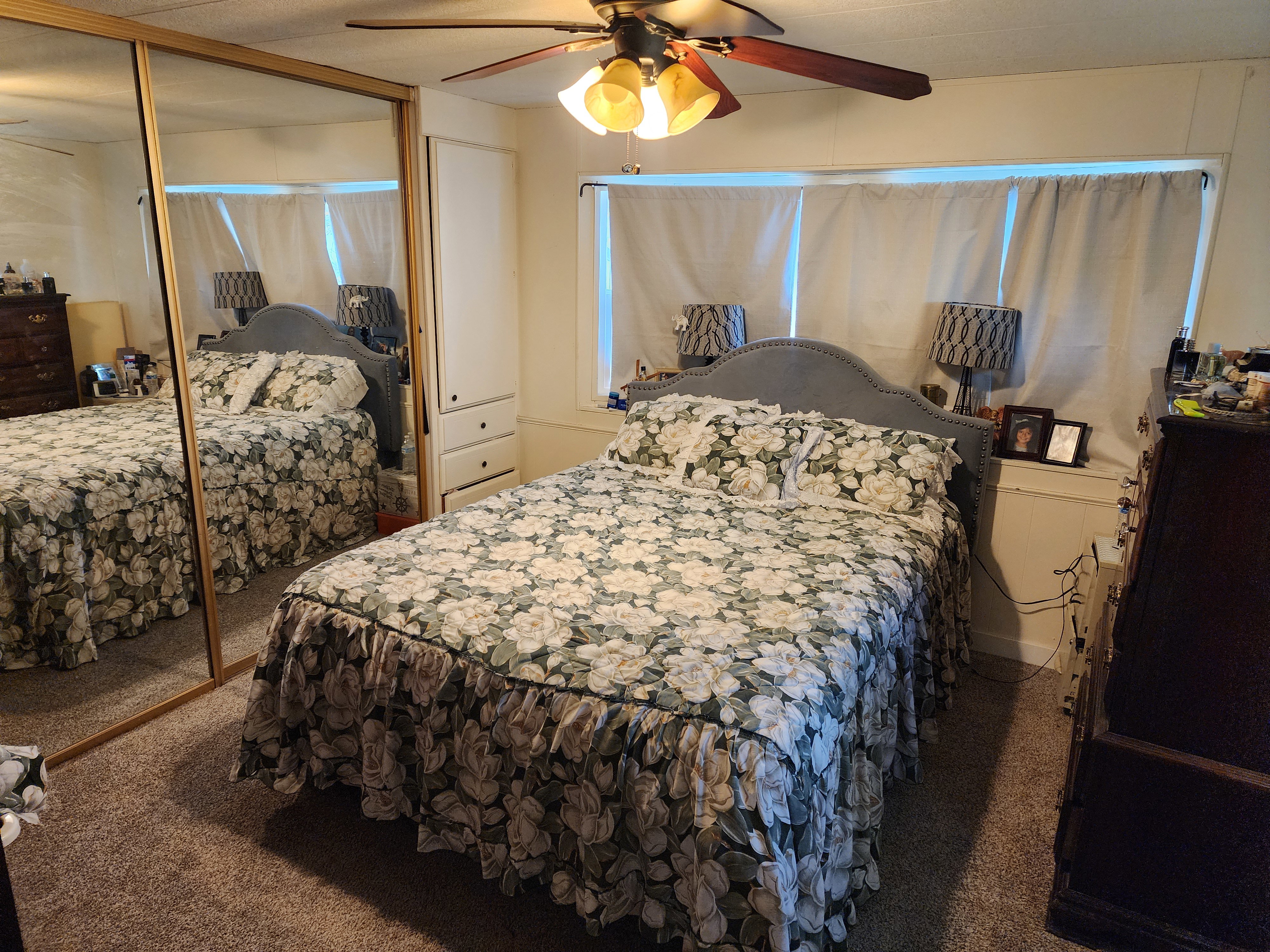 Carpeted bedroom with a closet and ceiling fan