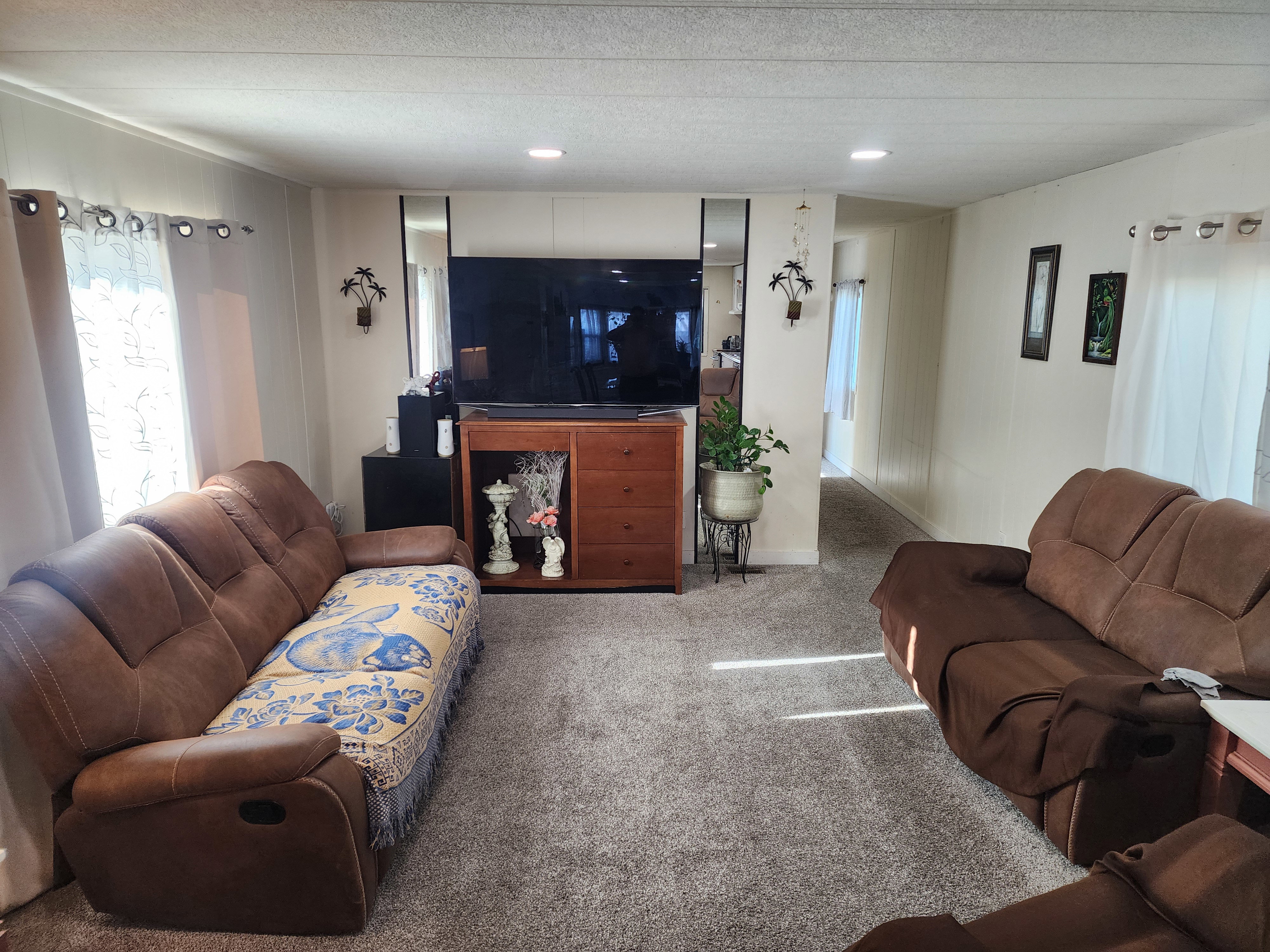 Carpeted living room with a textured ceiling