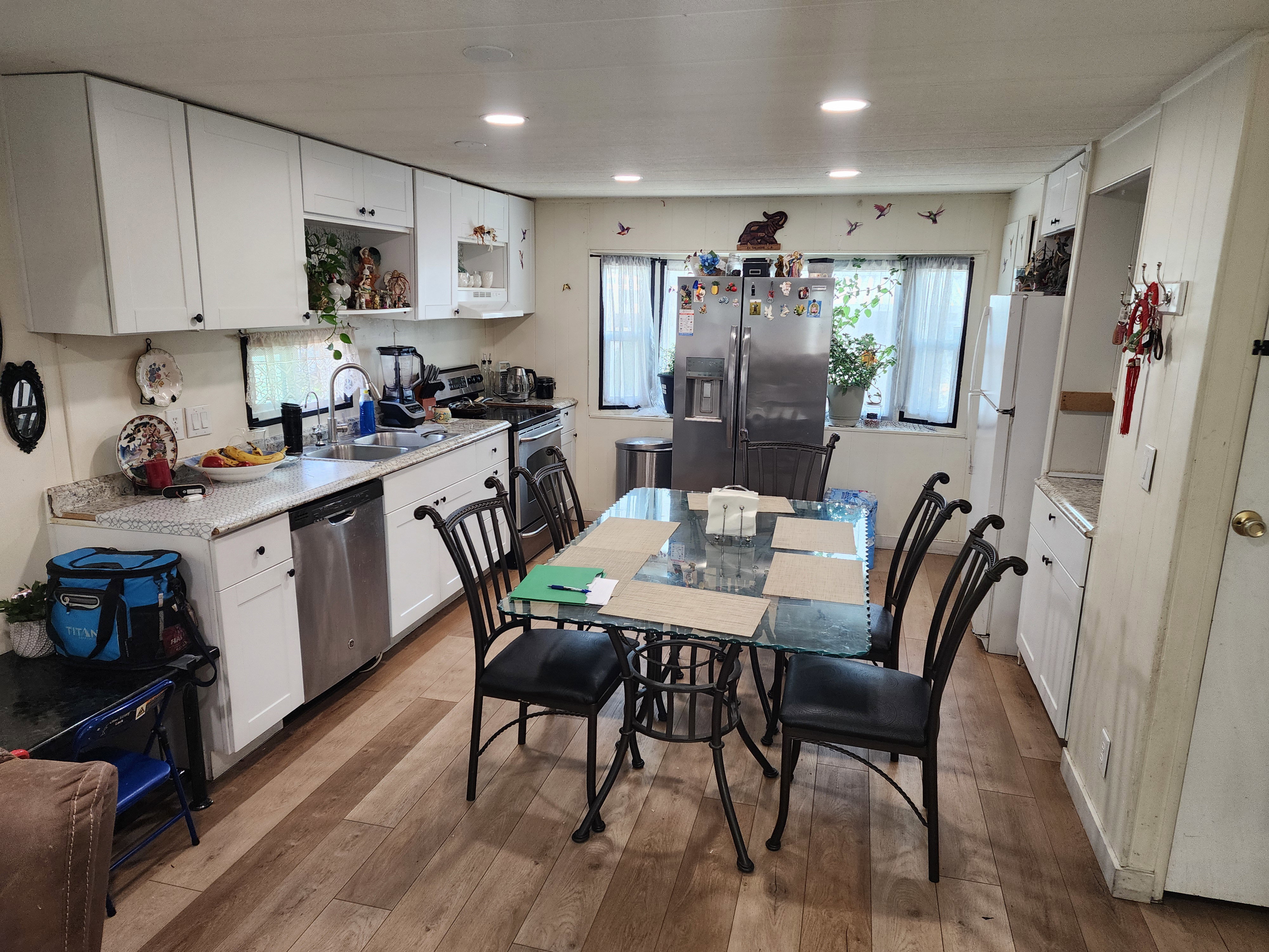 Kitchen with white cabinetry, stainless steel appliances, light wood-style floors, open shelves, and recessed lighting