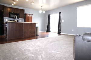 Great Room area with light carpet and a ceiling fan