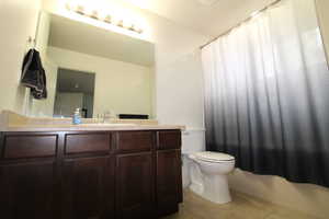 Full bath with vanity and light tile patterned flooring
