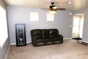 Great Room area with light carpet and a ceiling fan