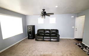 Great Room area with light carpet and a ceiling fan