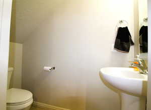 Guest Bathroom with toilet and baseboards