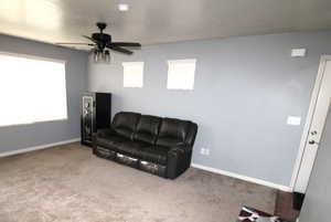 Great Room area with light carpet and a ceiling fan