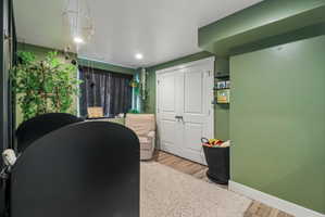 Office area with light wood-style flooring and recessed lighting