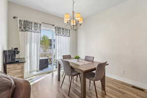Dining room featuring light wood finished floors and suspended lighting