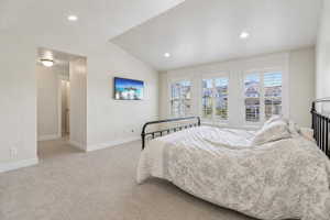Bedroom with vaulted ceiling, light colored carpet, and recessed lighting