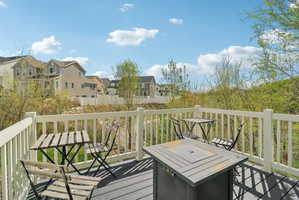 Deck with outdoor dining area and a residential view