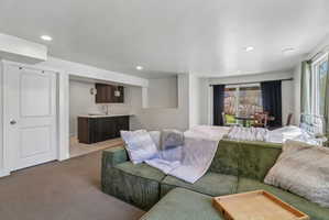 Living room featuring light colored carpet and recessed lighting