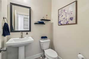 Bathroom featuring toilet and baseboards
