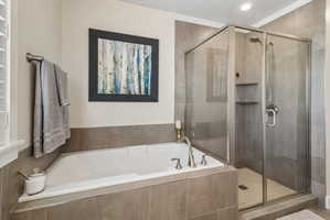 Bathroom with a stall shower and a bath