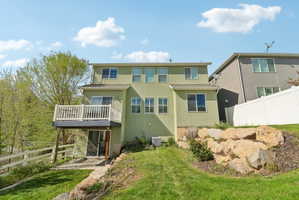 Back of house with stucco siding and a balcony