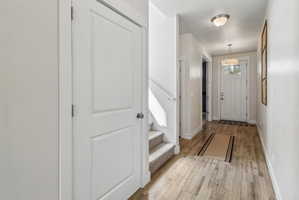 Entrance foyer featuring light wood-style floors and baseboards