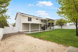 Rear view of house with a gate, a fenced backyard, and a patio