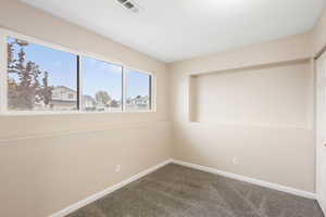 Empty room with baseboards and carpet flooring