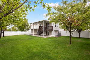 Rear view of property with a fenced backyard, a patio area, and a wooden deck