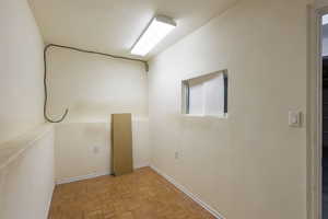 Empty room featuring parquet flooring and a textured wall