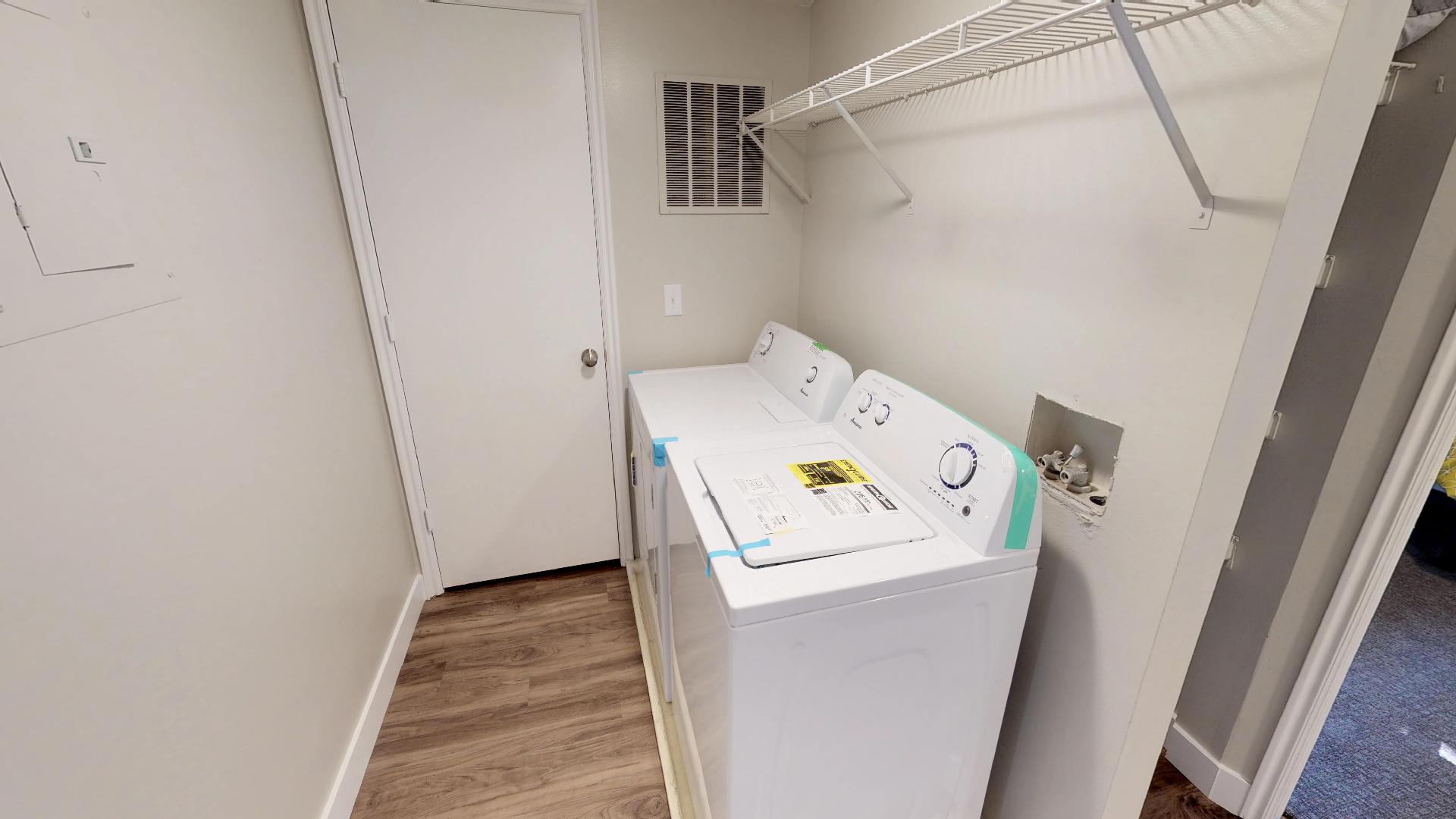 Laundry room featuring washer and dryer and light wood-style floors
