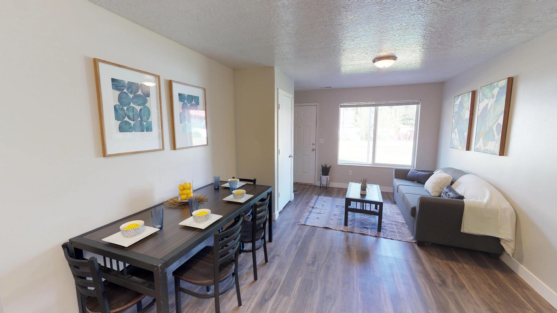 Dining area featuring a textured ceiling and dark wood-type flooring