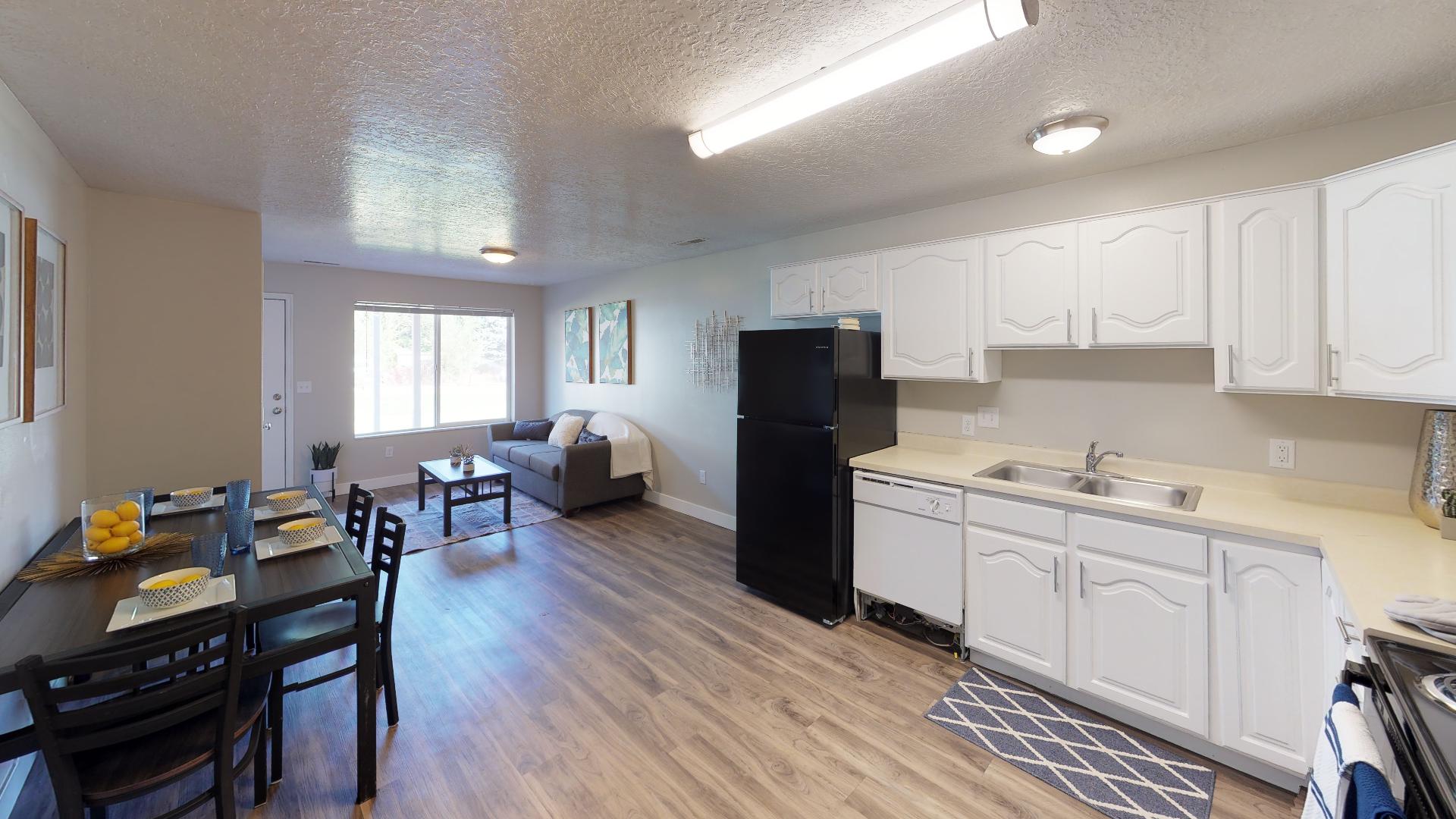 Kitchen featuring light countertops, white cabinets, range, and a textured ceiling