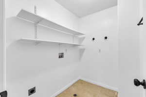Laundry room featuring washer hookup, light flooring, and electric dryer hookup