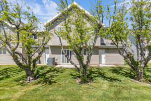 Rear view of house featuring a yard and a patio