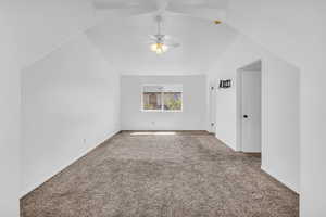Master bedroom with carpet, ceiling fan, and lofted ceiling