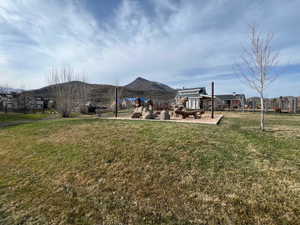 View of grassy yard with a mountain view