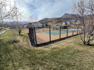 View of basketball court with a mountain view and a tennis court