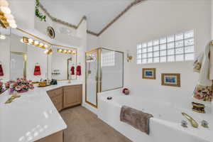 Bathroom featuring a stall shower, double vanity, light carpet, and a jetted tub