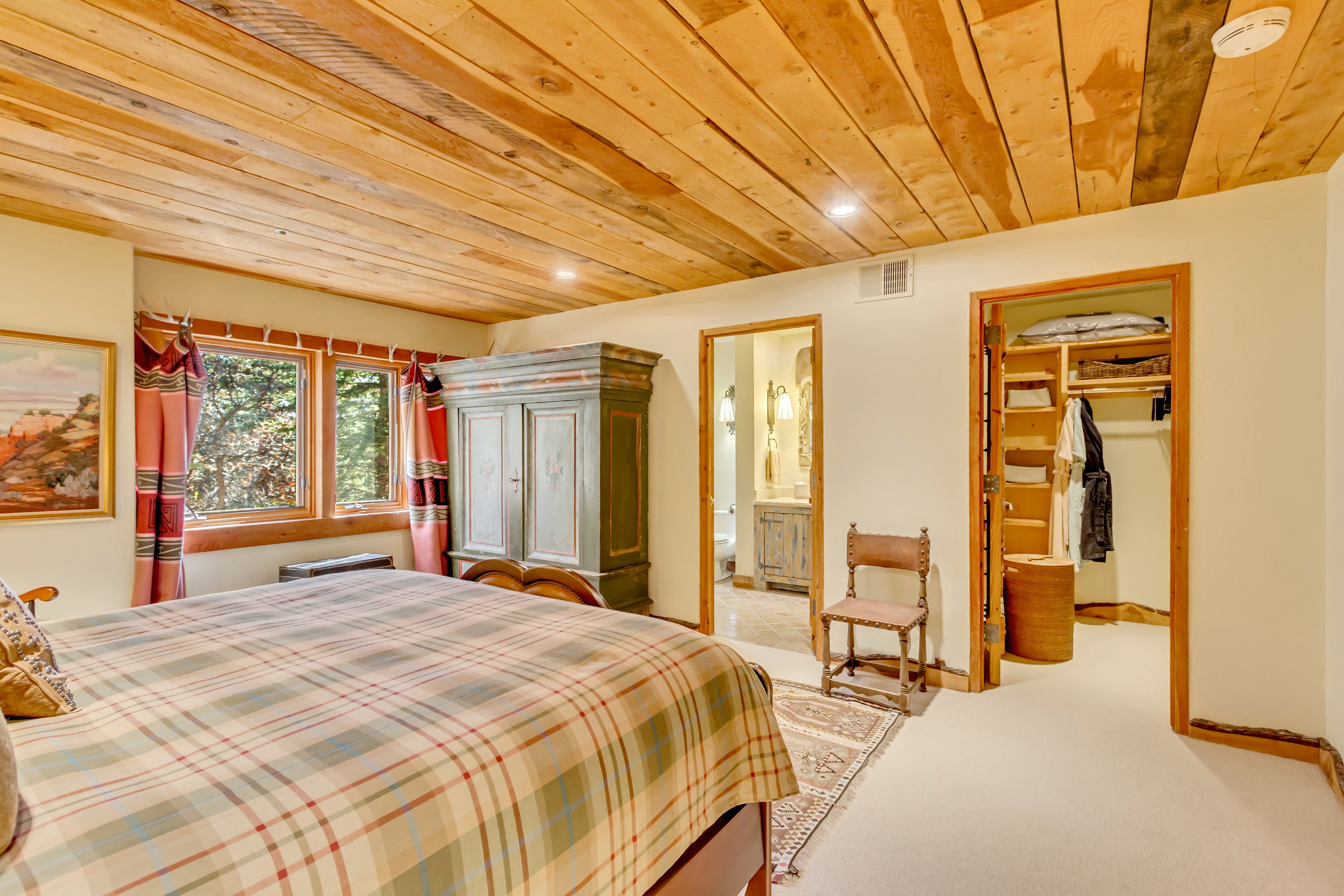 Bedroom with a walk in closet, wood ceiling, light carpet, and recessed lighting