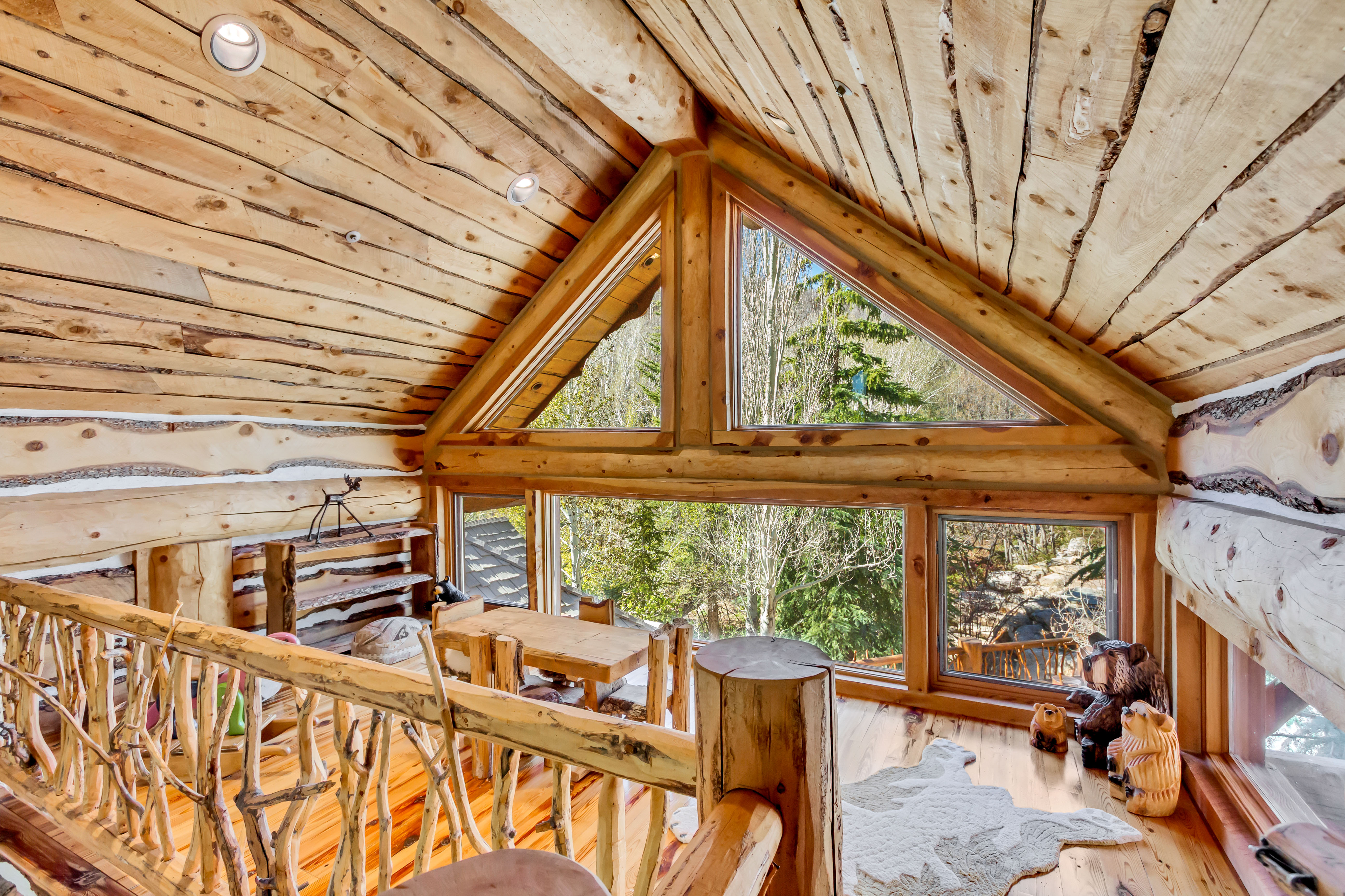 Living area featuring wood ceiling, wood-type flooring, and log walls
