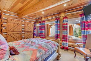Carpeted bedroom with recessed lighting and wood ceiling