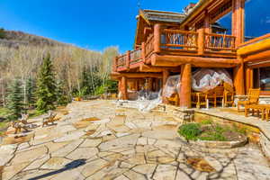 Patio / terrace featuring a patio area, a deck, and view of scattered trees