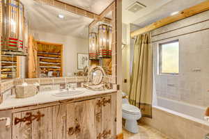 Full bathroom with vanity, light tile patterned floors, tiled shower / bath, and recessed lighting