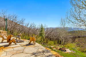 View of patio with a fire pit and a mountain view