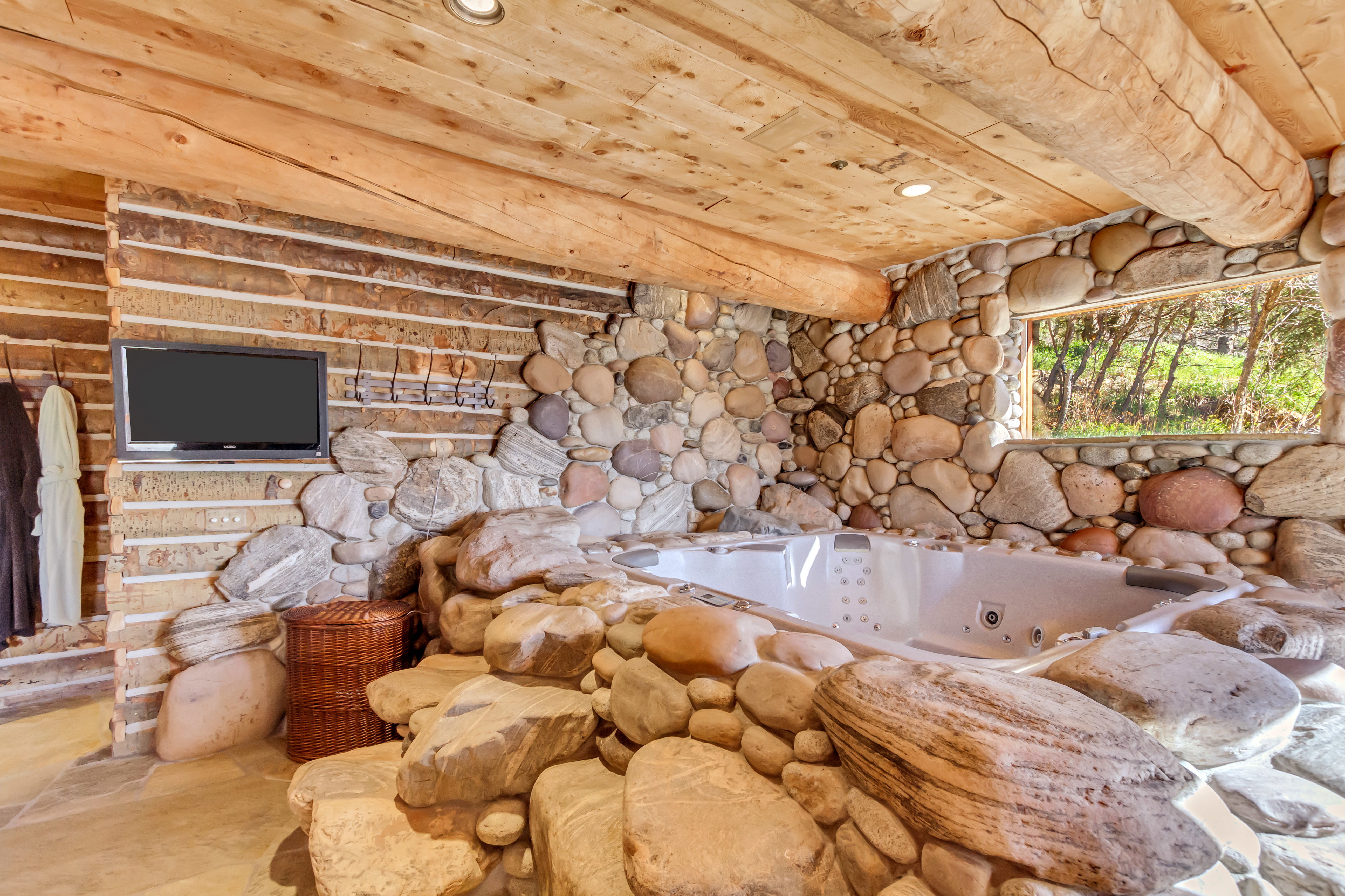 Detailed view of a whirlpool tub, wood ceiling, and recessed lighting