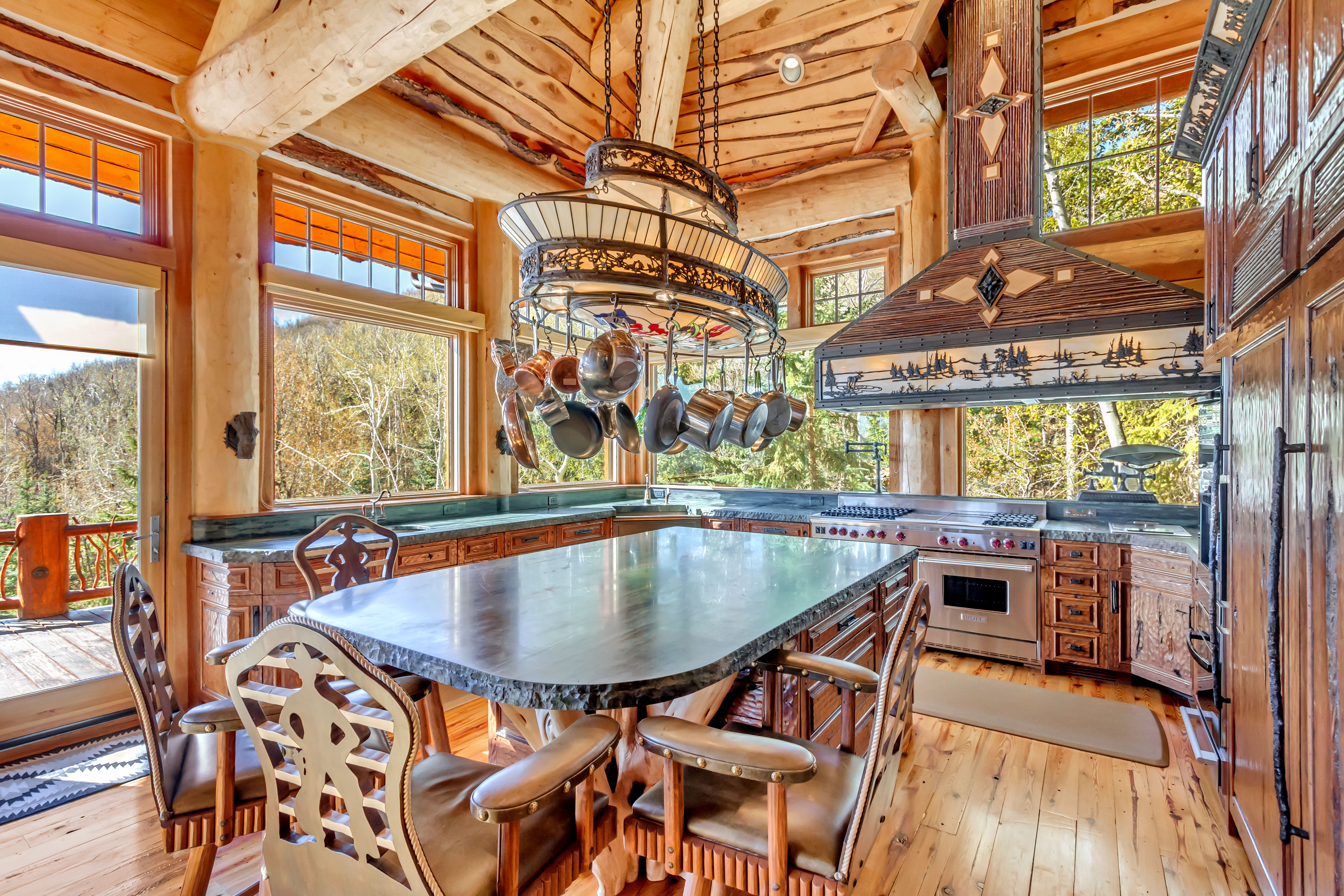 Dining area featuring light wood-style flooring and a high wooden beamed ceiling