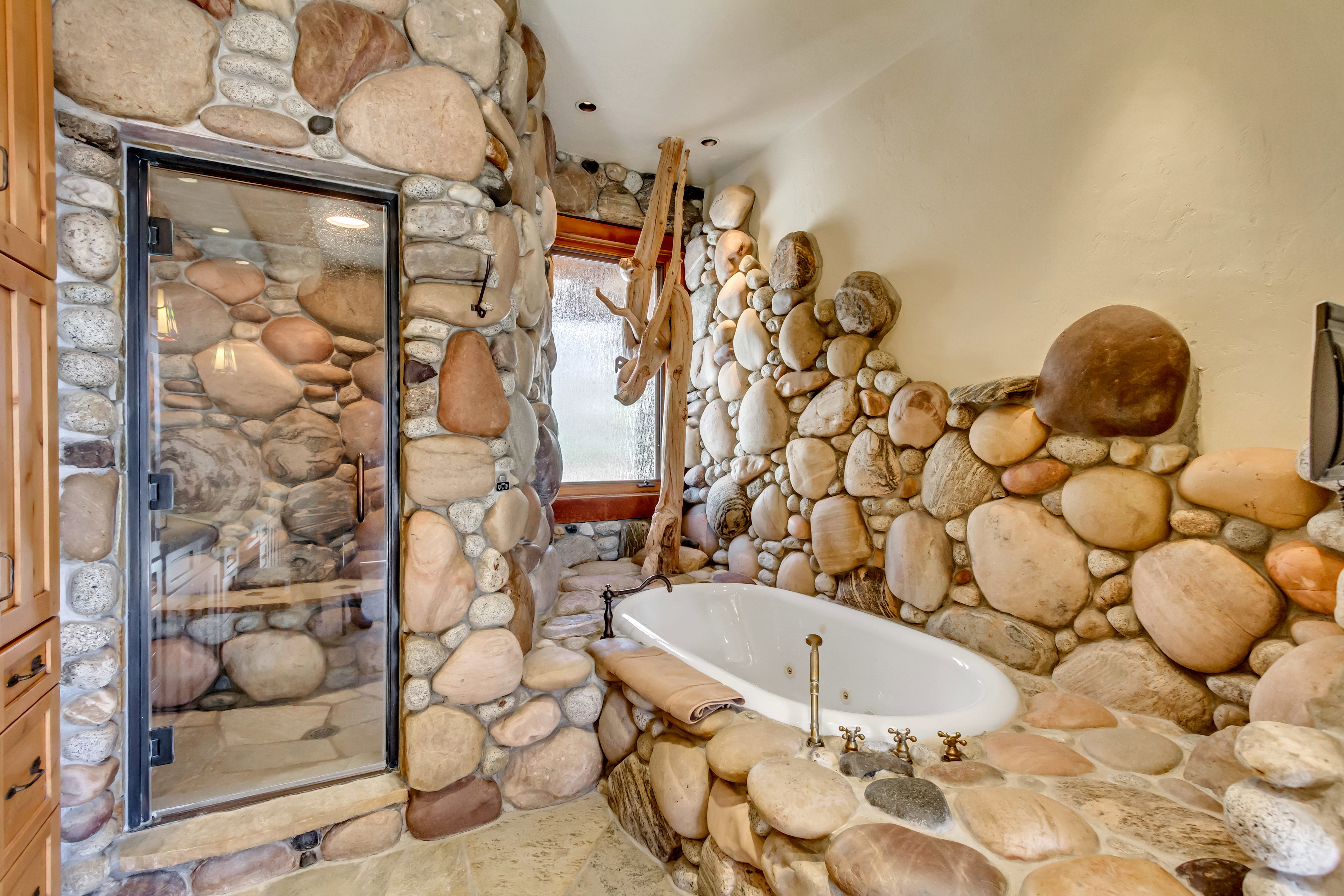 Full bath featuring a whirlpool tub and a stall shower