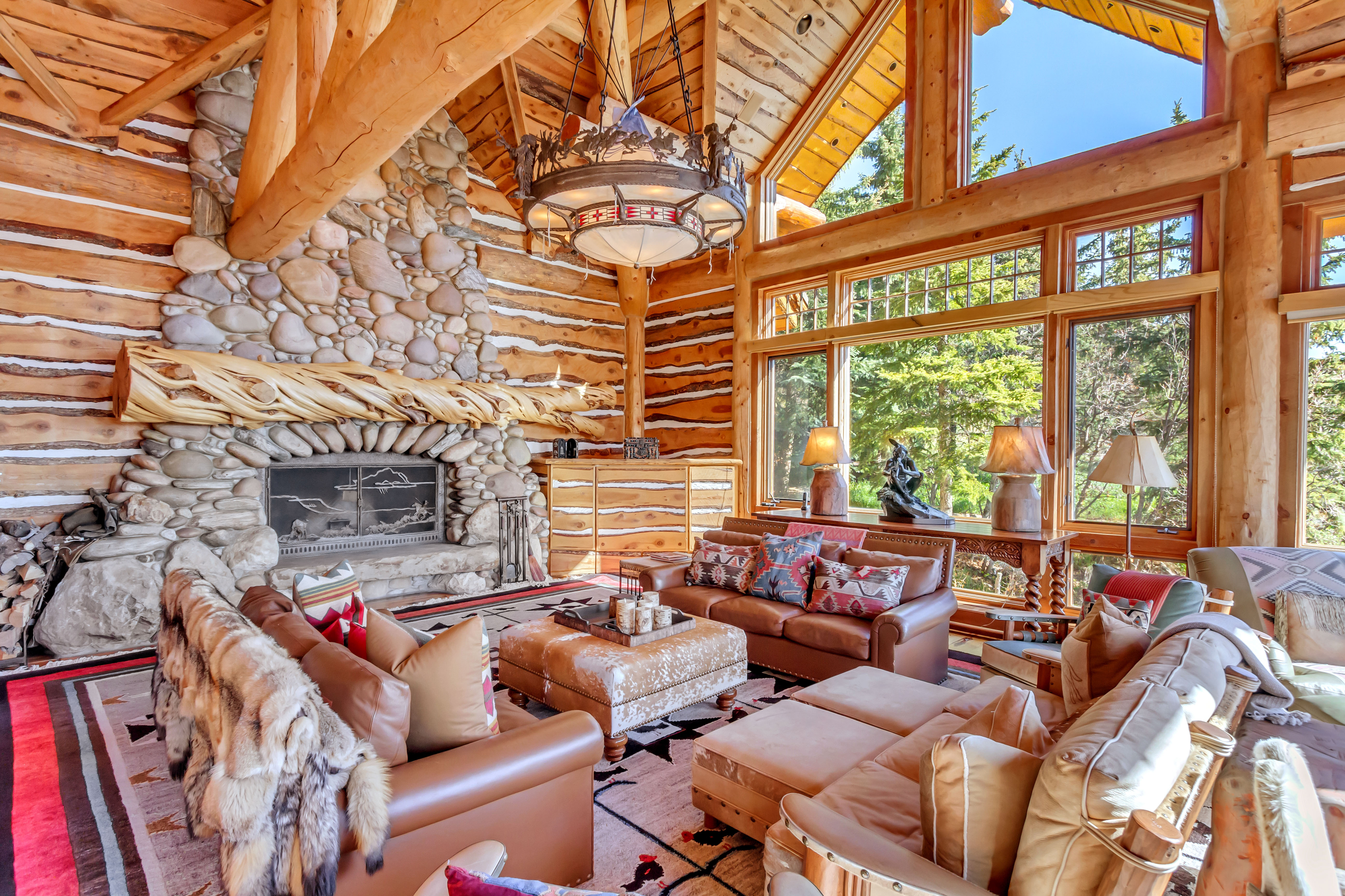 Living area featuring rustic walls, a high wooden ceiling, and a fireplace