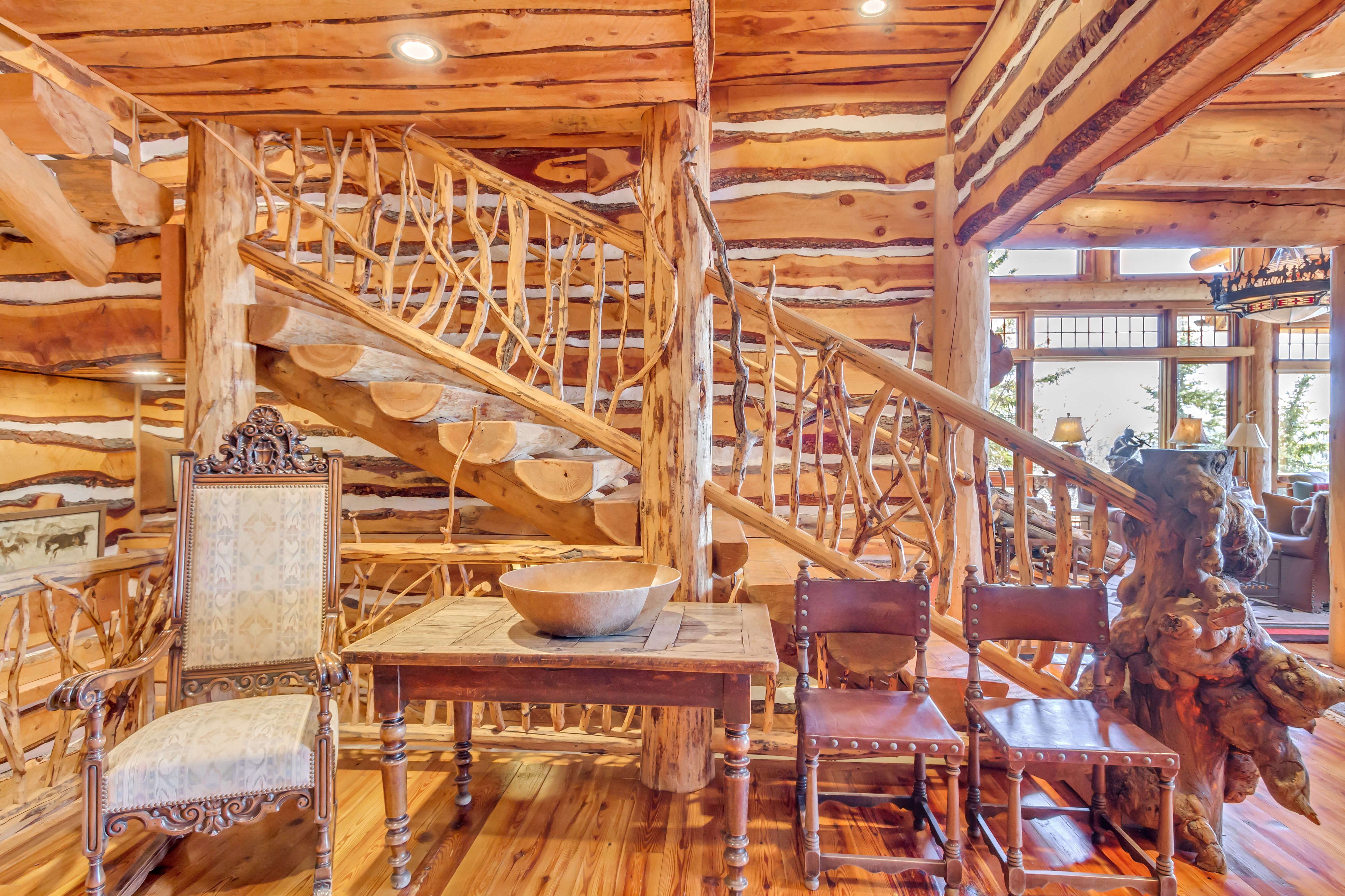 Dining area with hardwood / wood-style floors and log walls