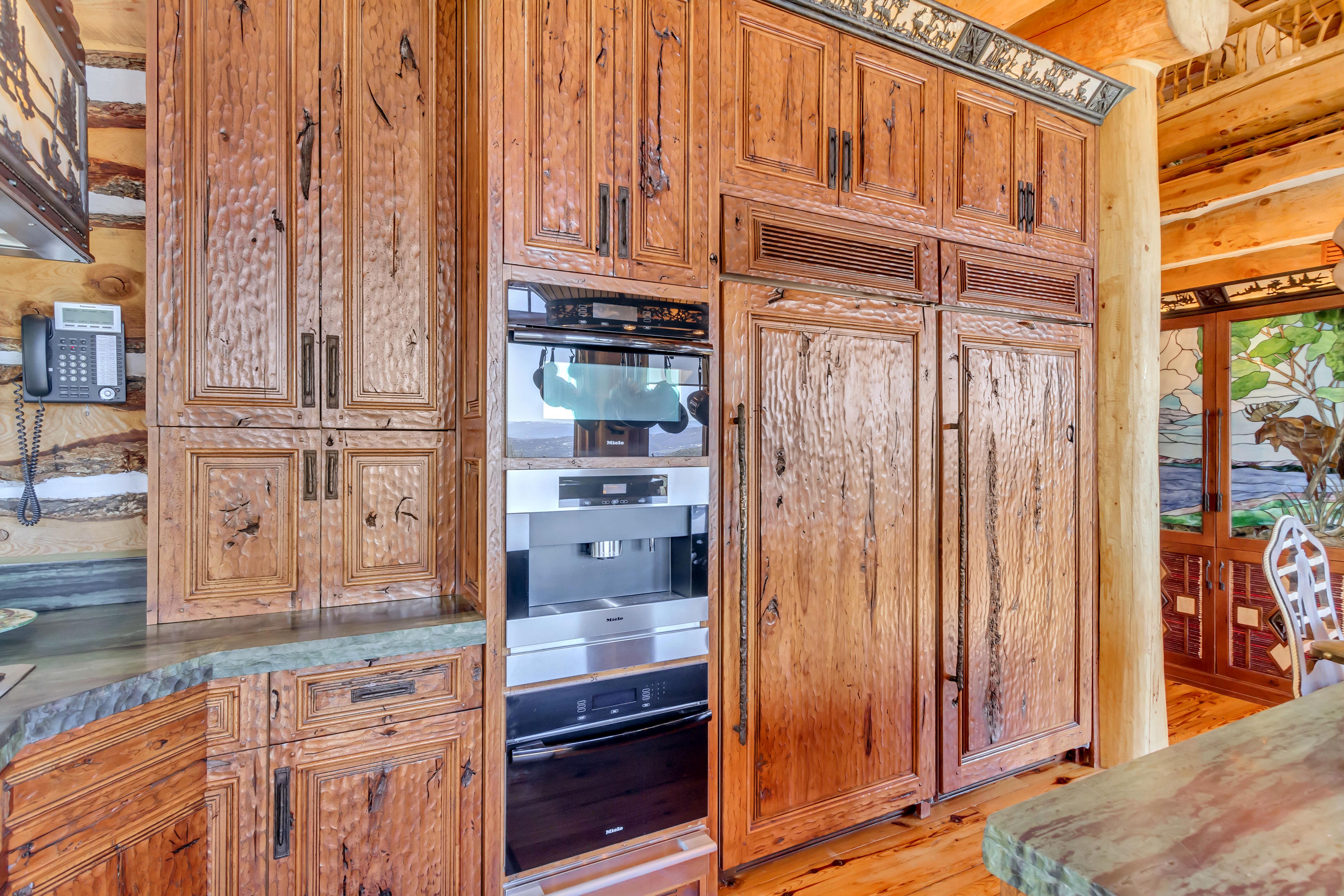 Kitchen featuring wood finish cabinets, oven, and paneled refrigerator