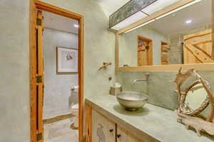 Bathroom with vanity and recessed lighting